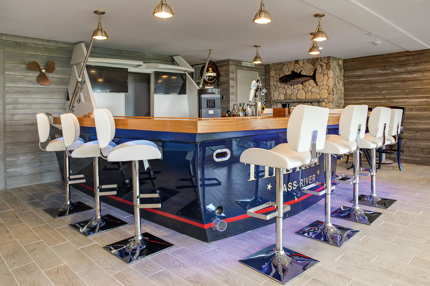 Real-life boat repurposed as a bar for a Cape Cod game room by Sand Dollar Customs builder and remodeler