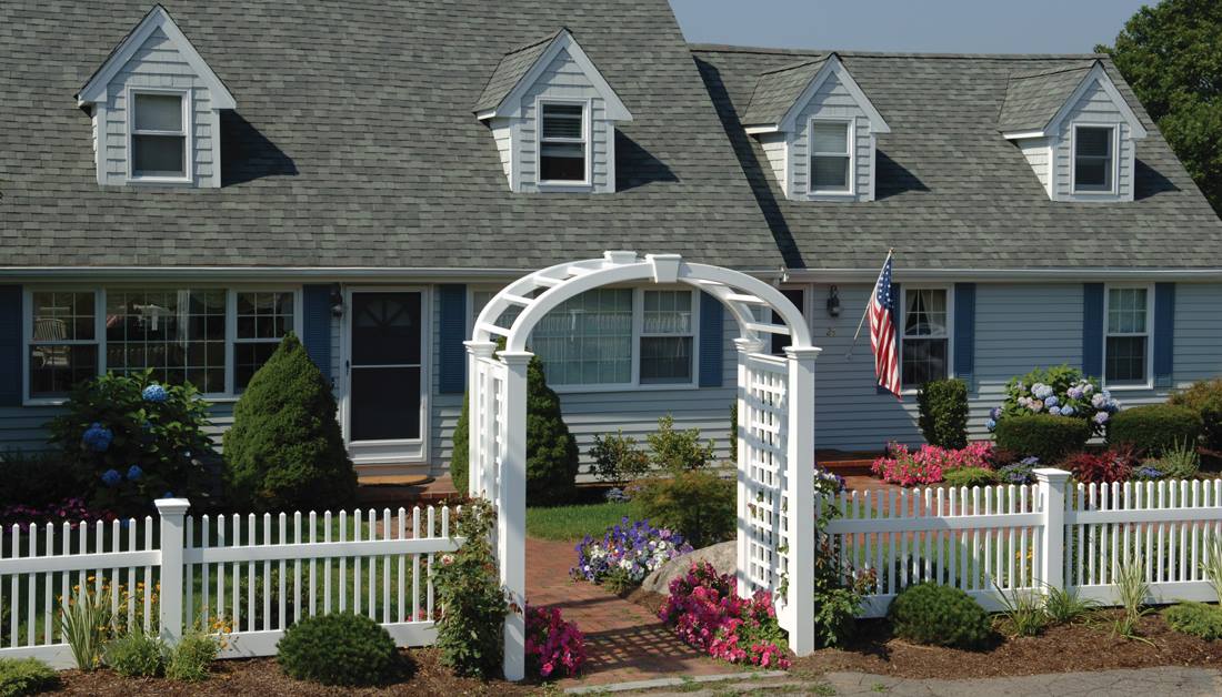 Perfection Fence’s Mt. Vernon Line of ForeverVinyl fencing and elliptical Grand Arbor with English Lattice side panels & keystone adornment beautifully enhance the look of this traditional Cape Cod style home.