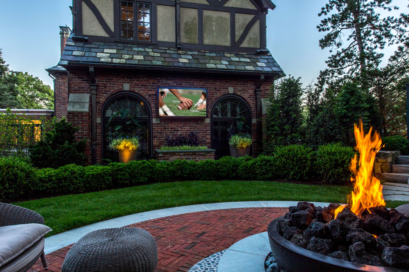 Landscape design featuring an outdoor TV, with home integration by Creative Systems