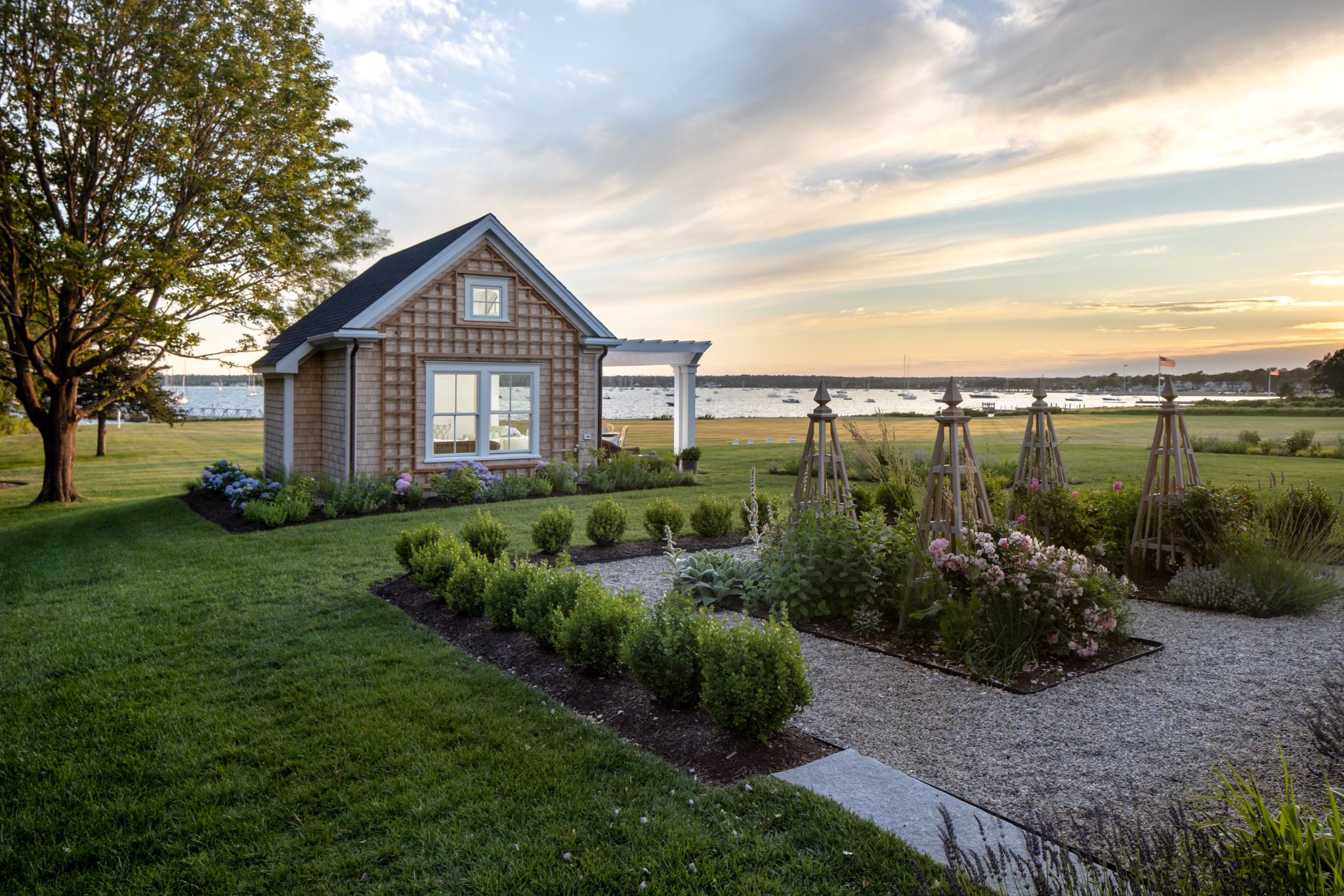 Mattapoiset Tea House, side view exterior of gardens and water.