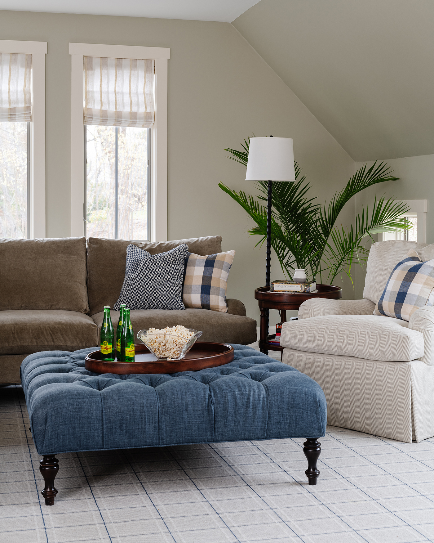 Sitting area with blue ottoman and food and drink tray