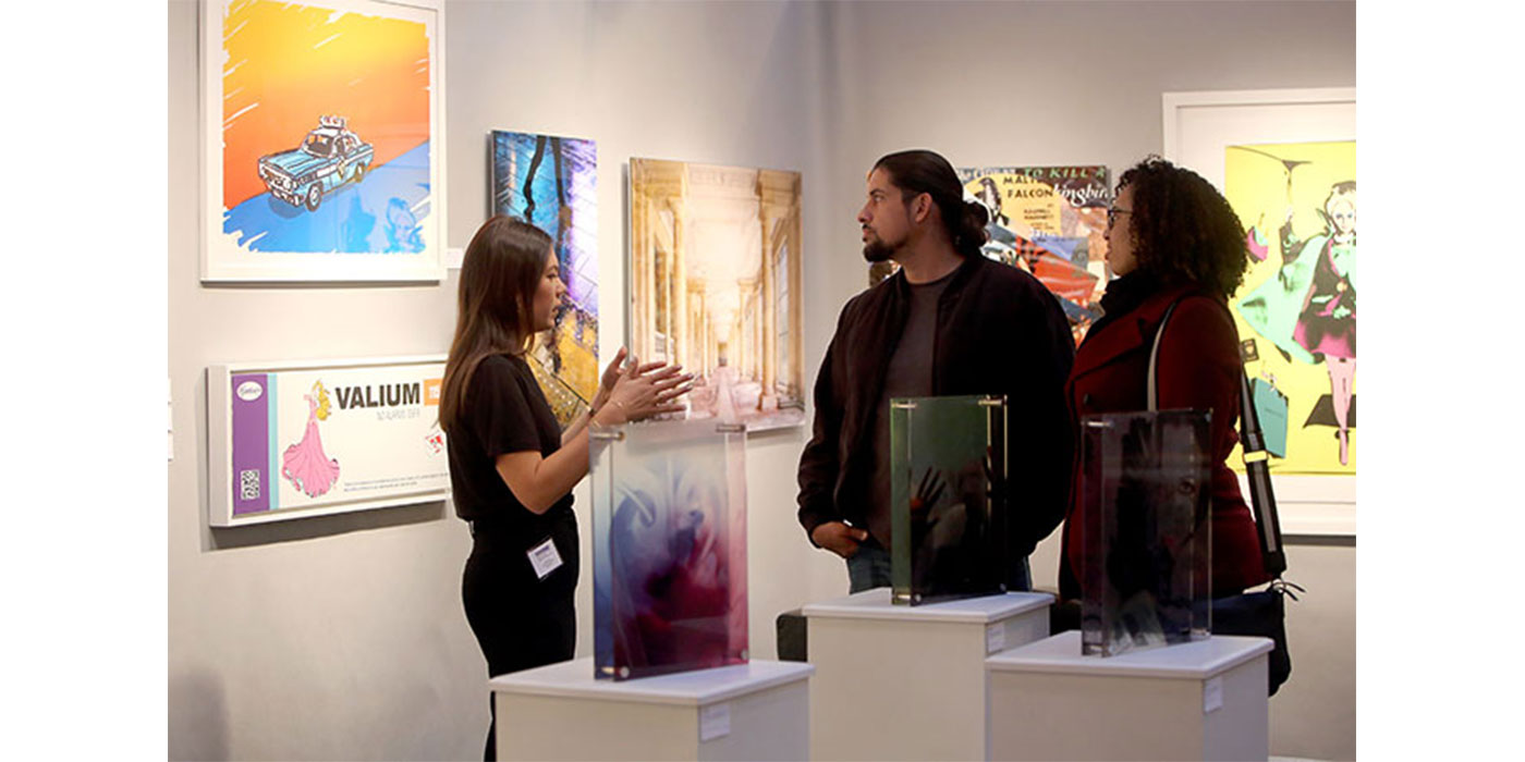 Eventgoers speak to art experts at the Boston International Fine Art Show