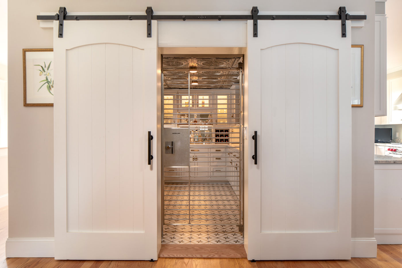 white barn doors that open up to a butler's pantry converted from a bank vault