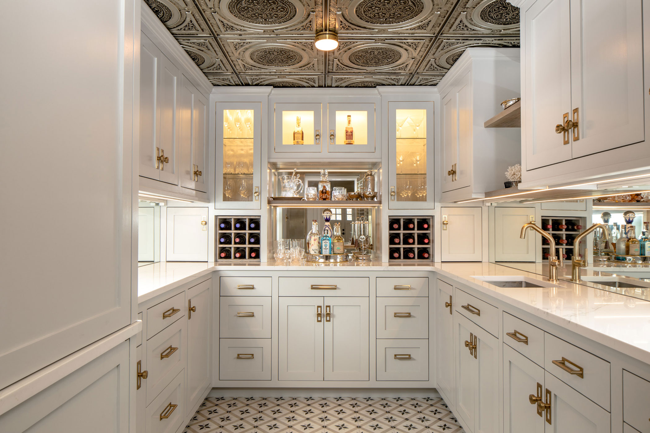 Butler's pantry converted from a bank vault with tin ceilings and white cabinets