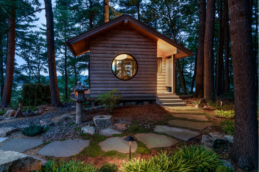 Wooden Japanese tea house in garden at night
