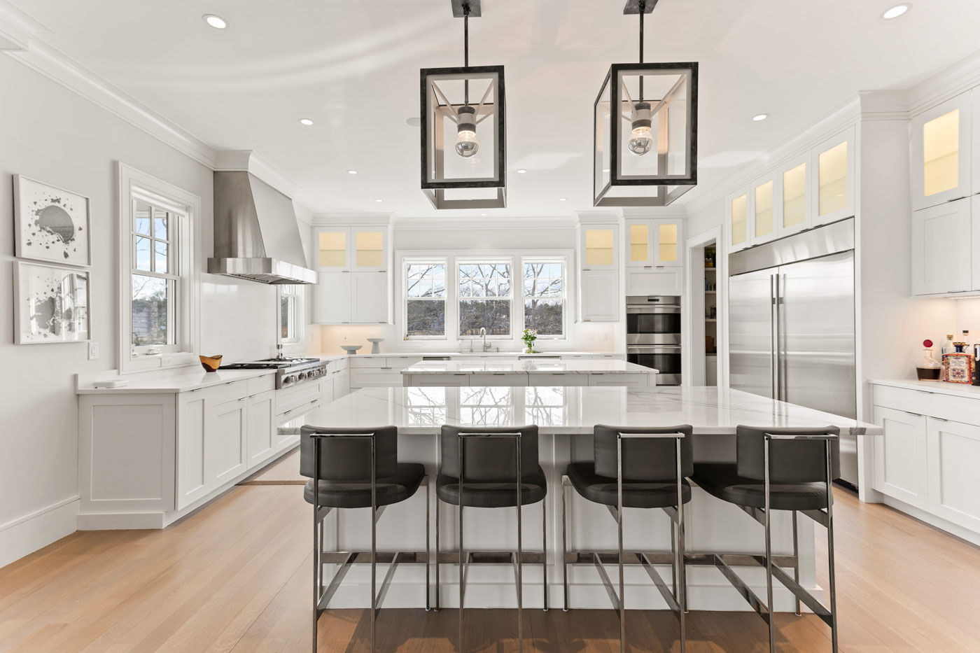 modern white kitchen with 2 big stone islands in the center