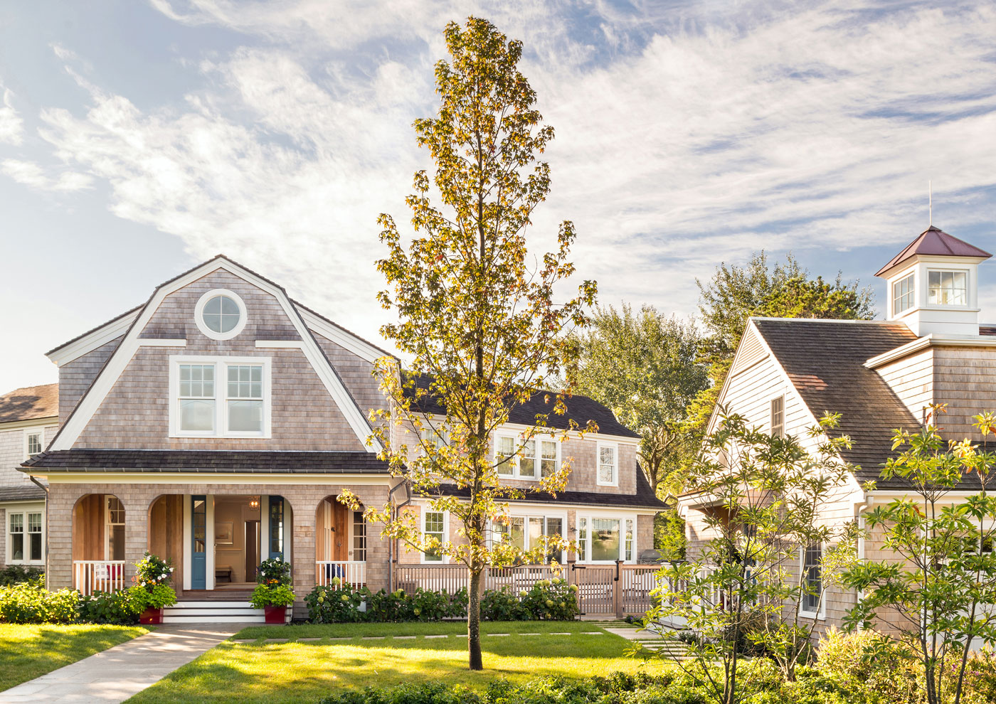 Front view of house on cape cod with front door open