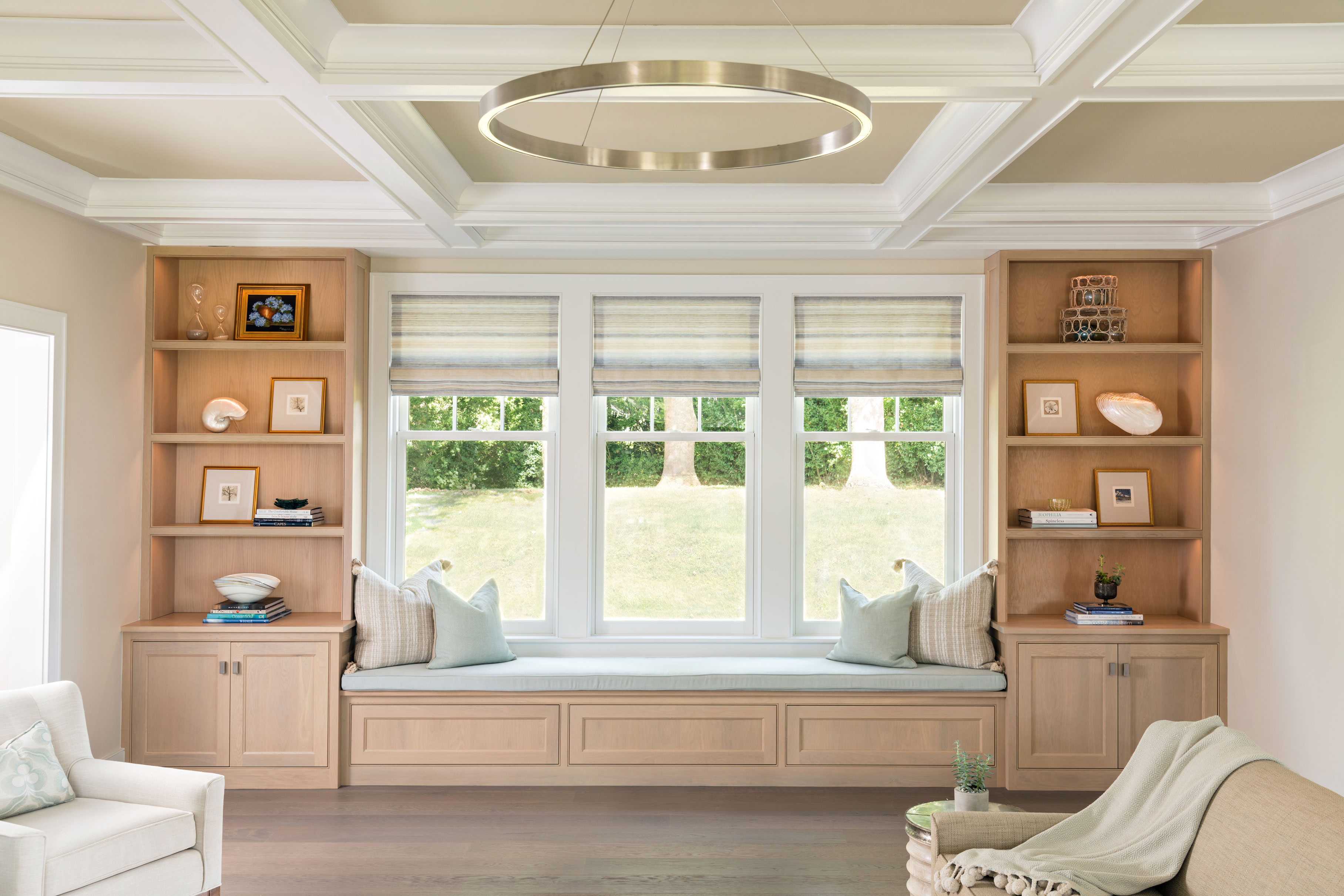 family room with custom built in window seat and shelving