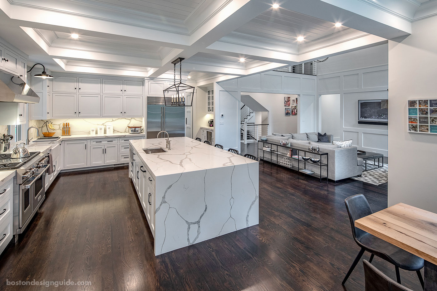 Open-floor kitchen into dining room by Concept Building Inc.