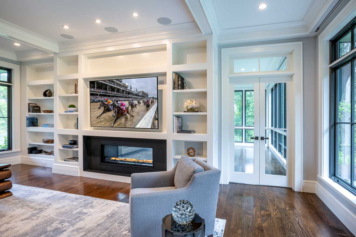 Shingle style home in rural wooded setting - room with built-in cabinets designed by Curl Simitis Architecture + Design