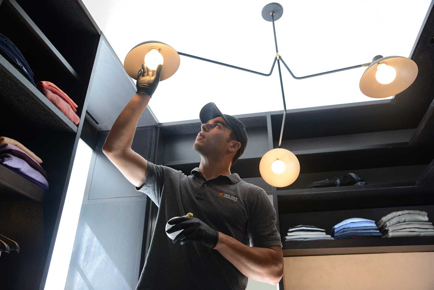 Man changing lightbulb in closet