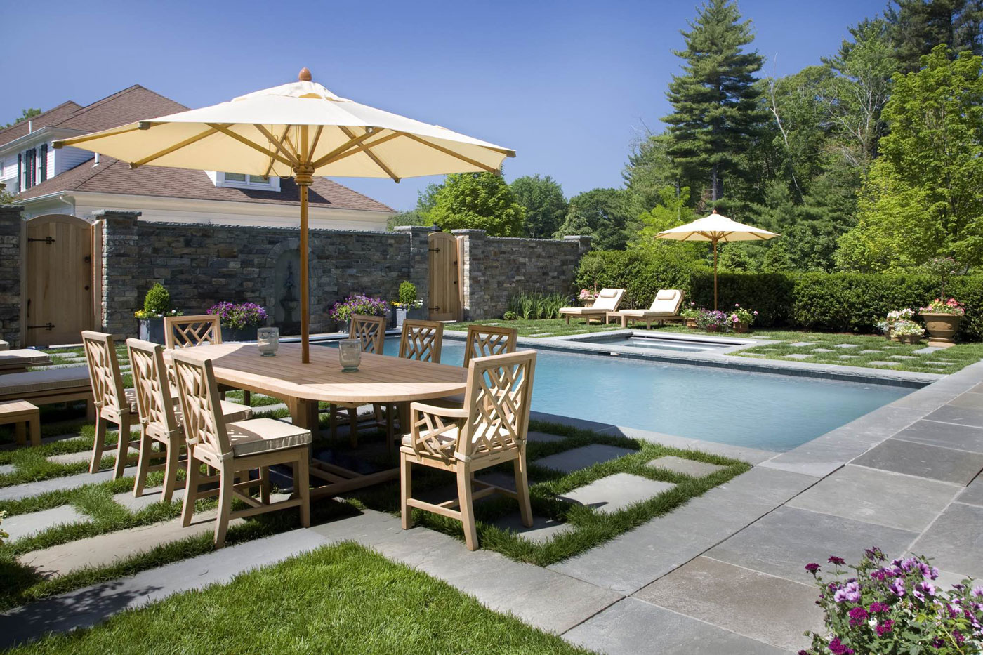 Pool with outdoor dining table and lounge chairs