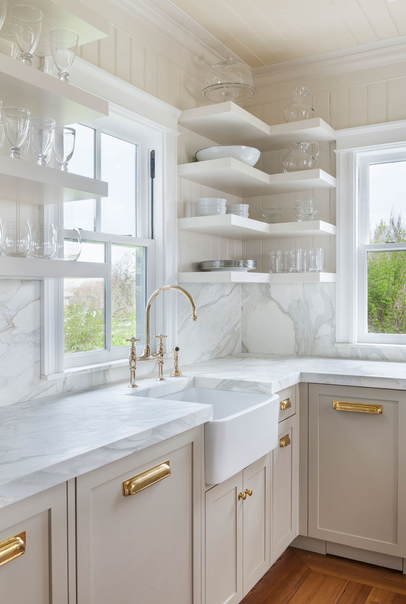 white kitchen with open shelving and apron sink