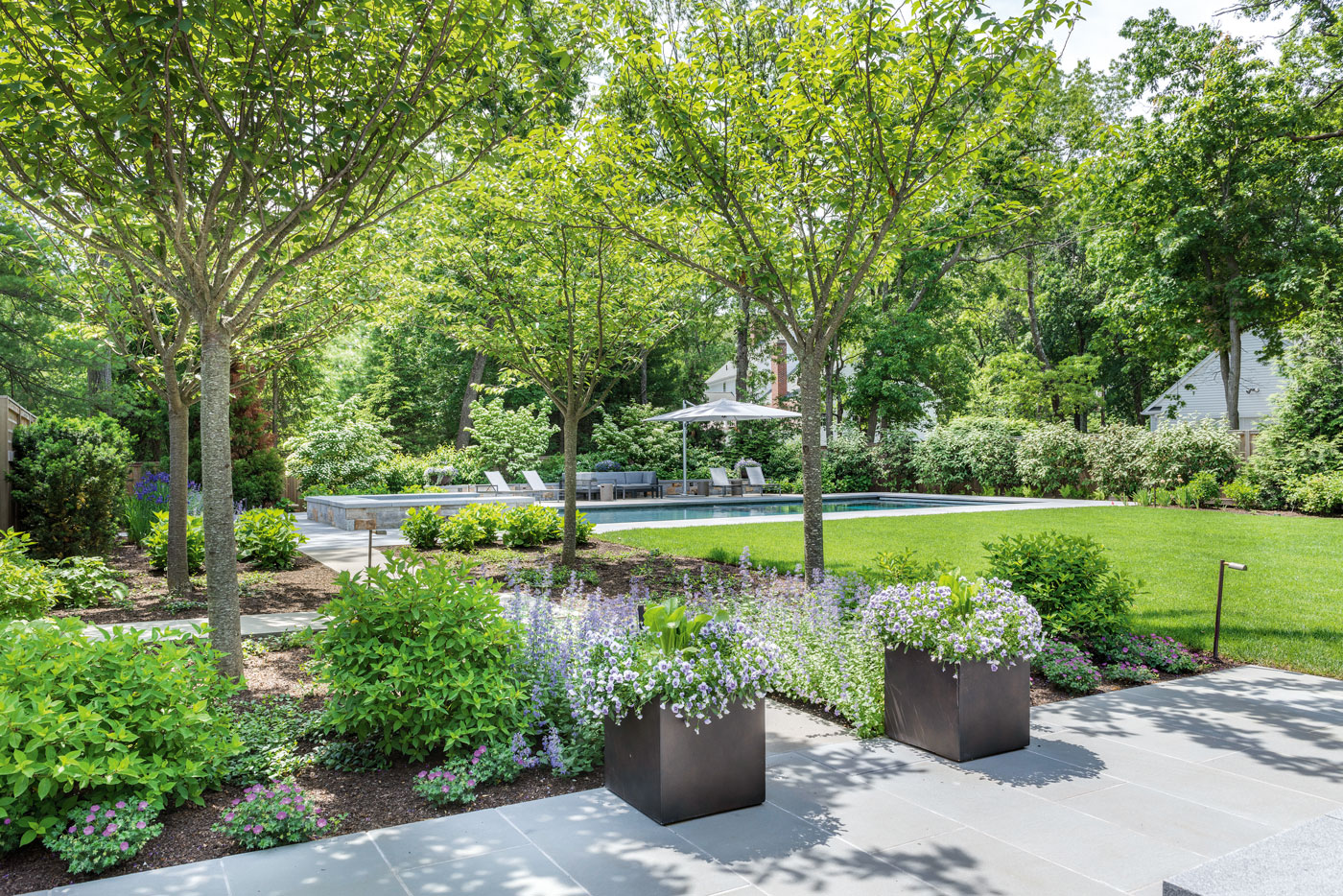 Swimming pool terrace and grounds designed by landscape architect Gregory Lombardi Design and built by Landscape Creations for a high-end custom suburban Boston home. 