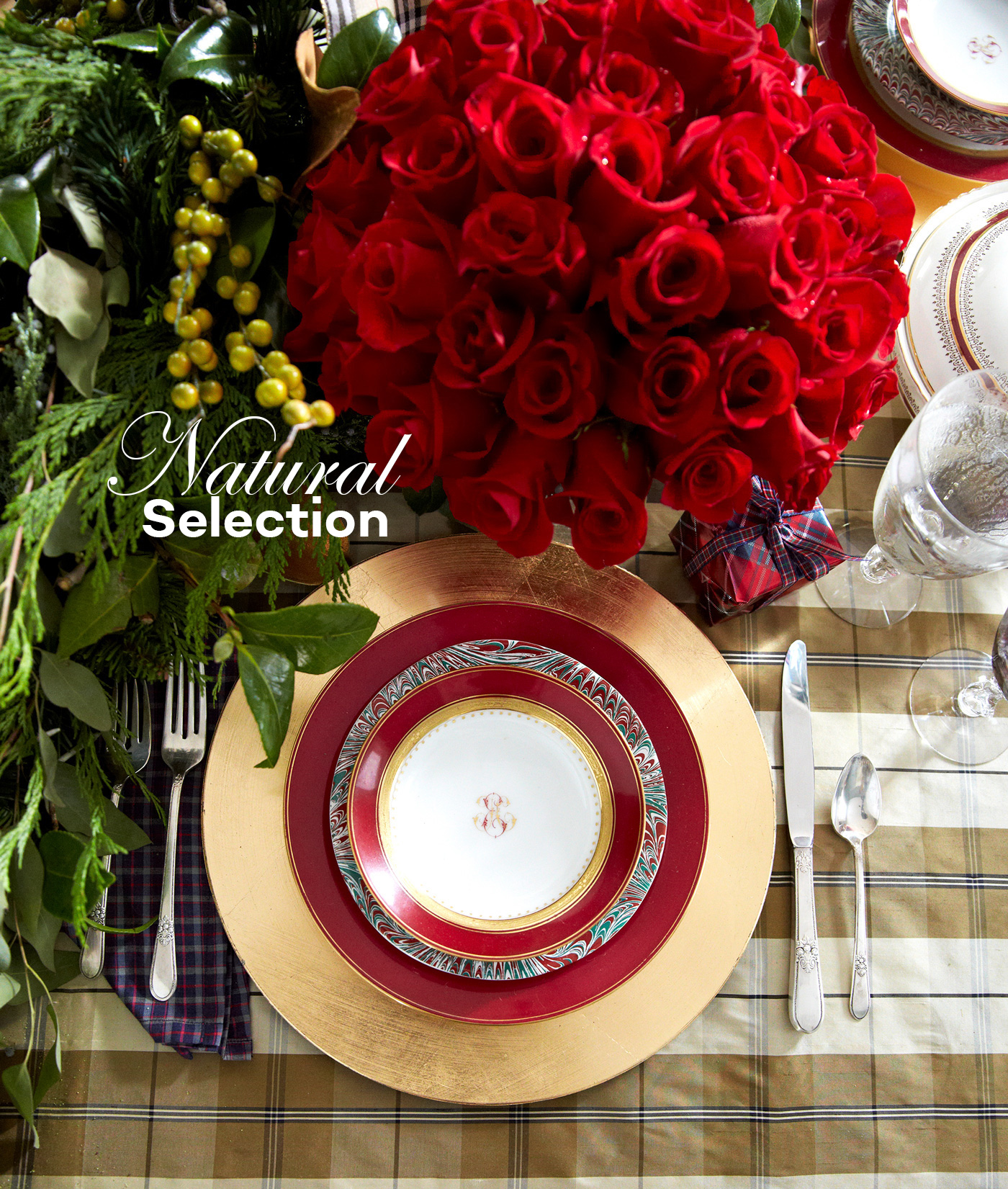 Holiday place setting with greenery and roses