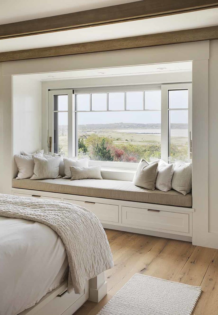 Window seat in bedroom with a view of the water