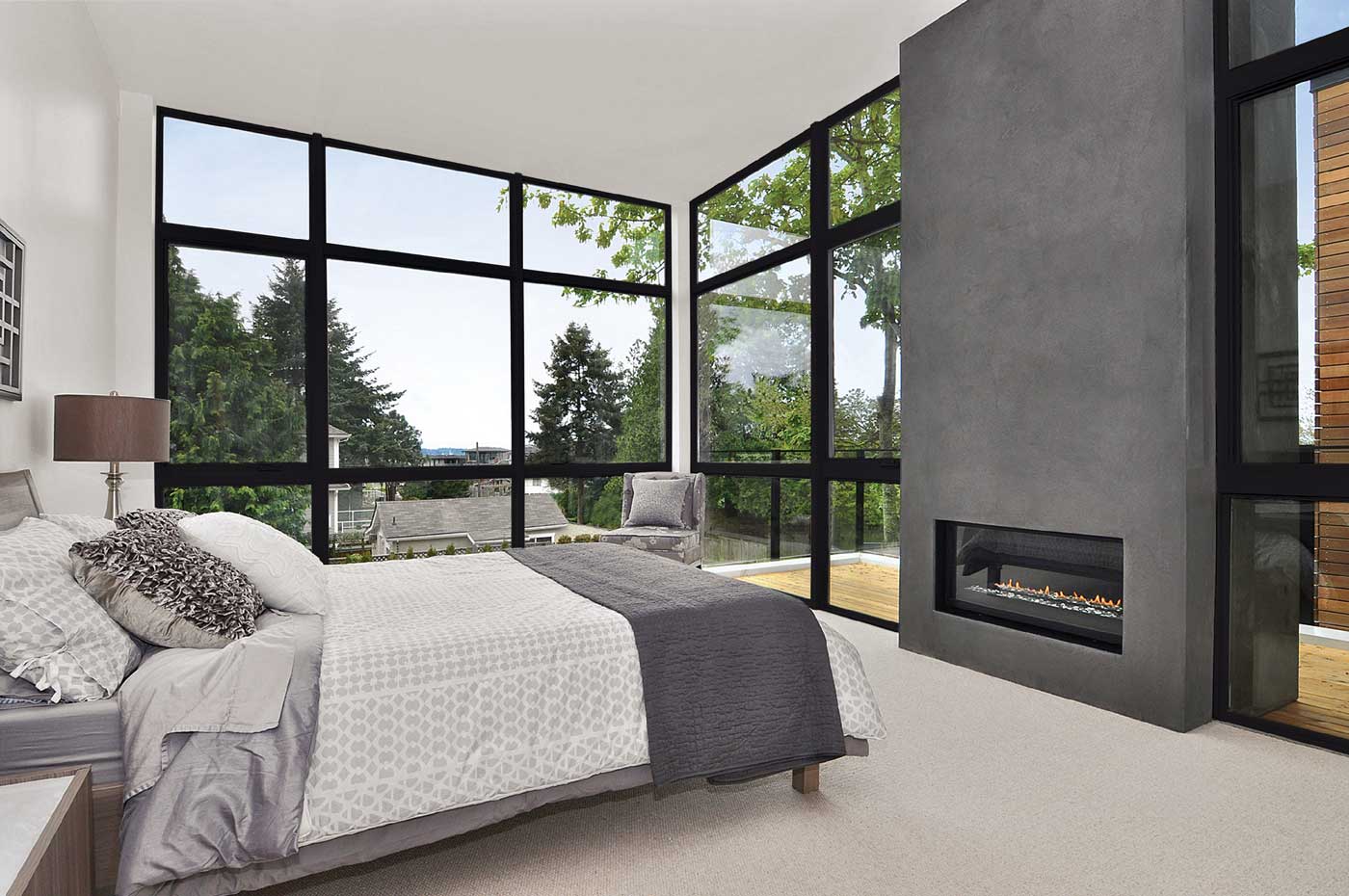 bedroom with big windows and fireplace