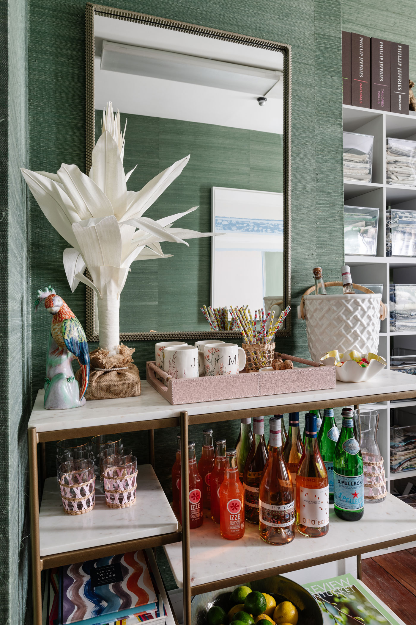 shelving in the corner of the office with drinks, glasses, straw and mugs