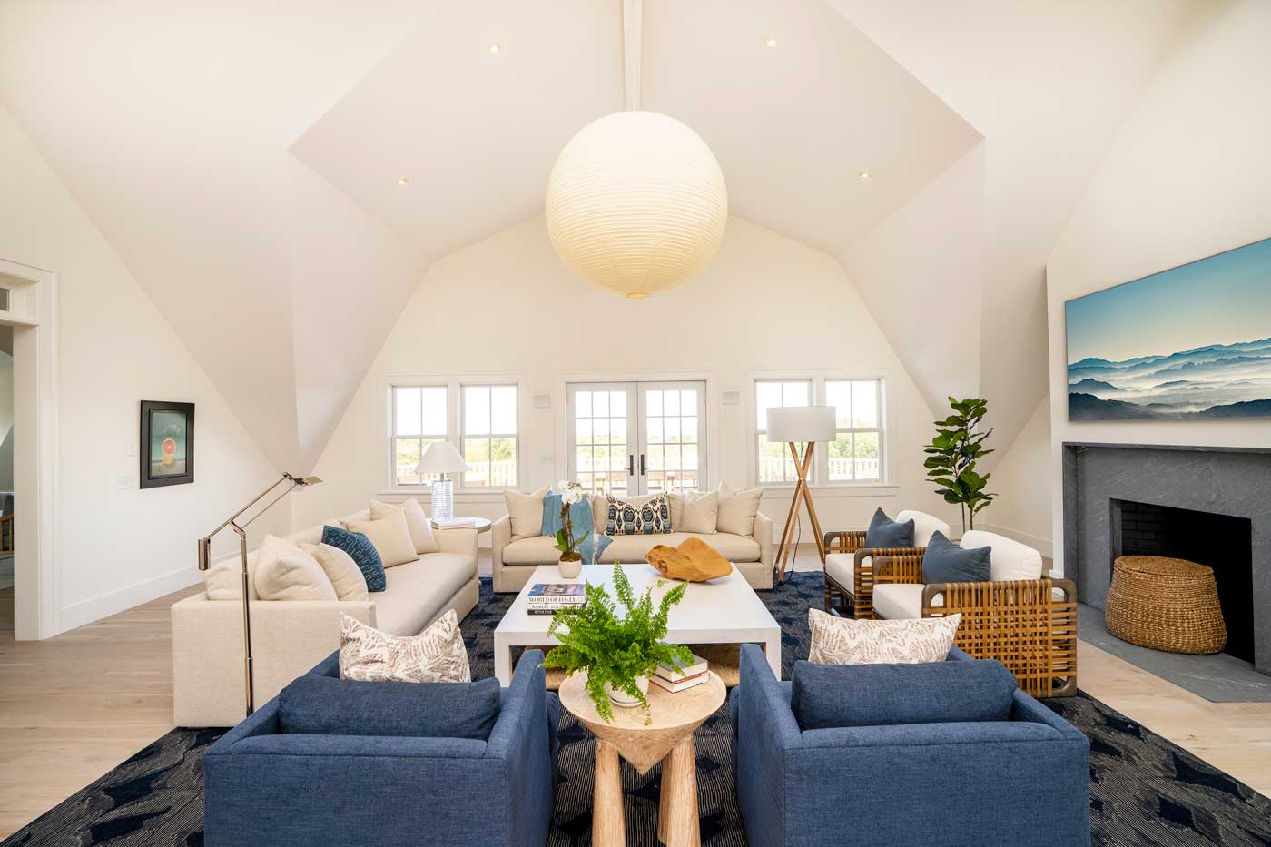 family room with off white sofas blue chairs and cathedral ceiling