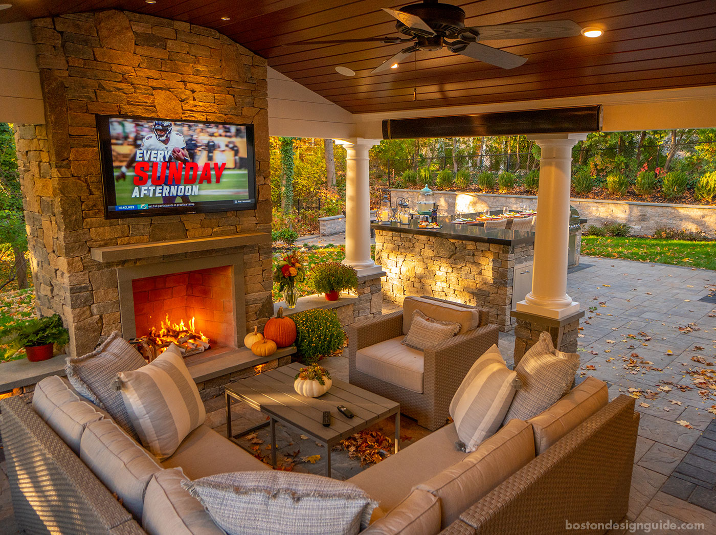 Outdoor porch with TV, fireplace and heaters by Land Design Associates