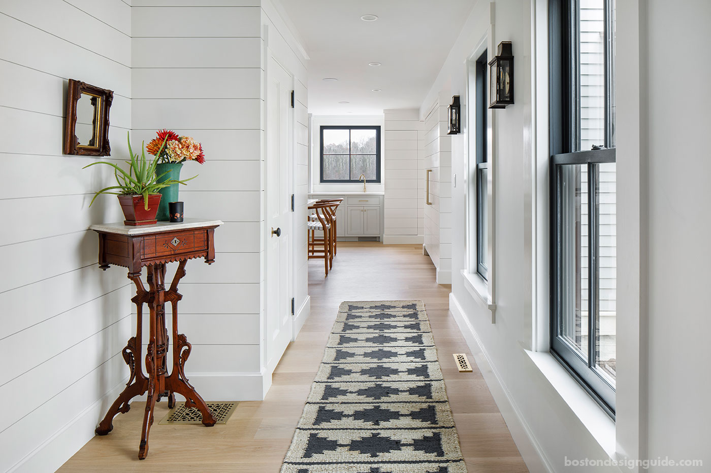 Nickel gap wood paneling lines a custom hallway by McCormack Builders