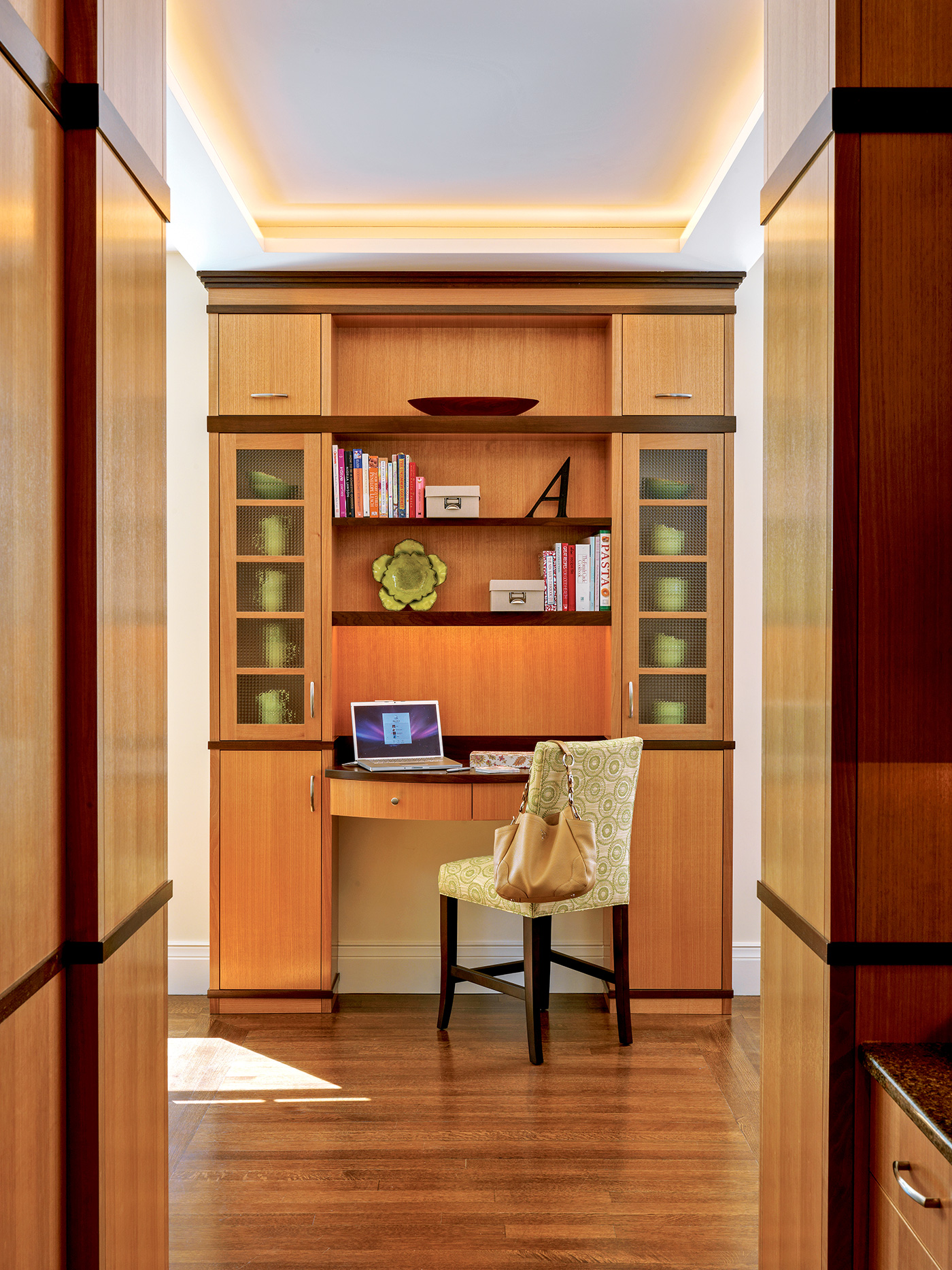 Home office space with custom millwork in a hallway design by Nicholaeff Architecture + Design