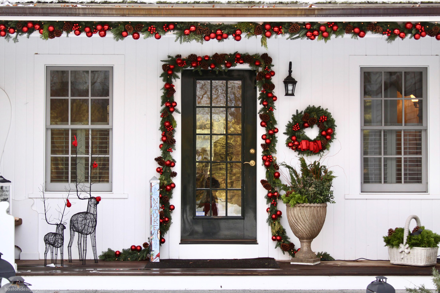 New England home in red holiday decorations by Parterre Garden Services