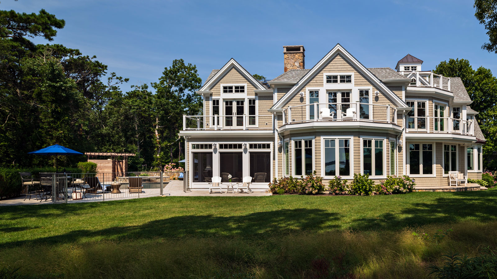 back view of home with a pool