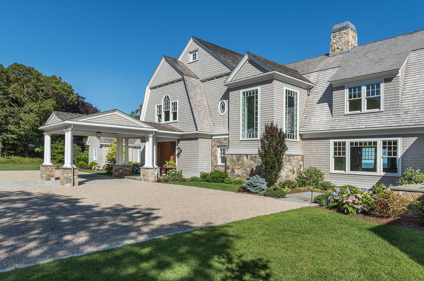 Cape Cod custom home with a porte-cochère by builder Rogers & Marney