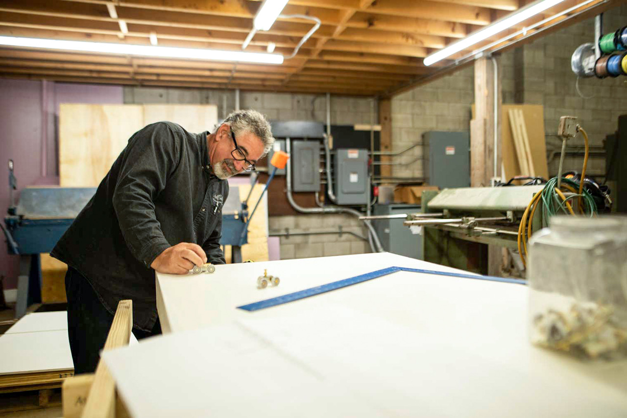 Don Lake, co-founder of RootCellar works on custom door