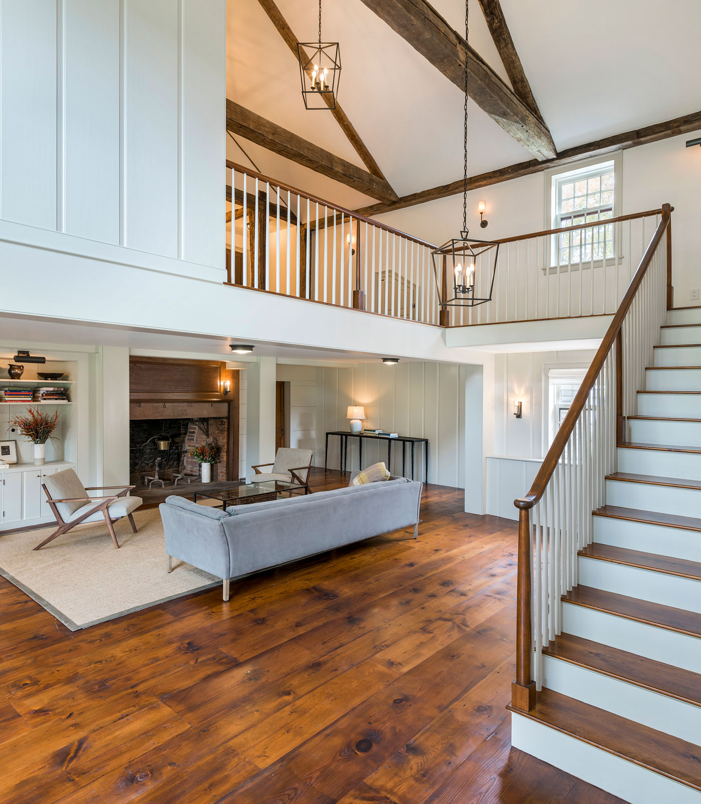 custom living area with vaulted ceilings and a stairway that leads to open second floor