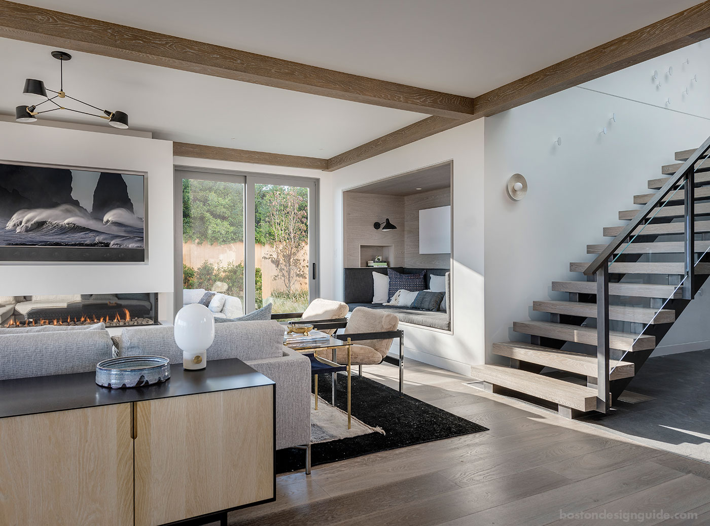 The modern living room and stair of a Cape home on the ocean designed by Duckham Architecture & Interiors