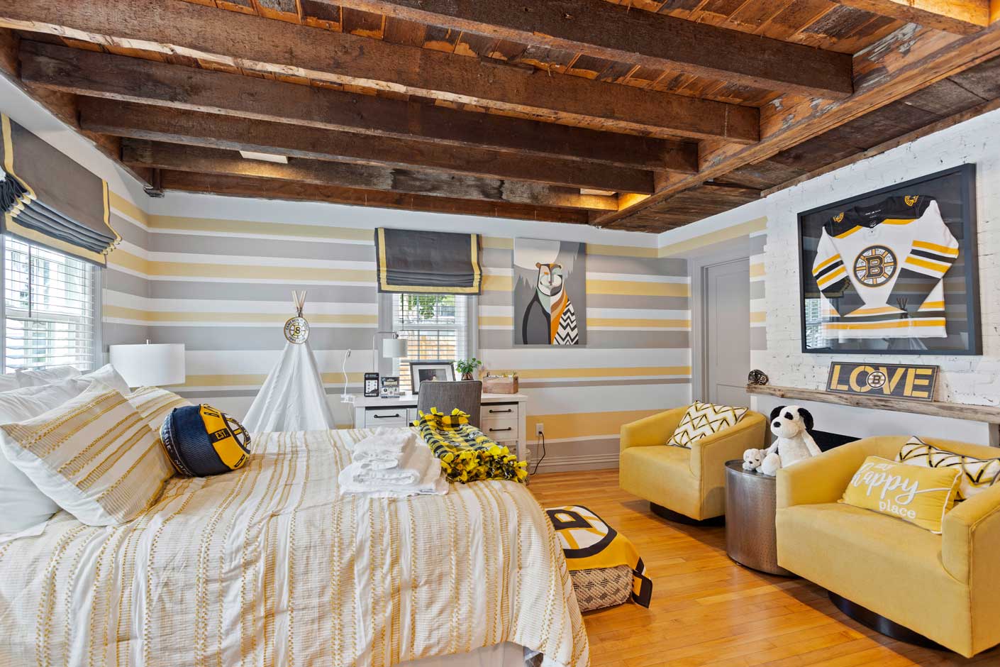 bedroom with wood ceiling and bruins jersey on the wall