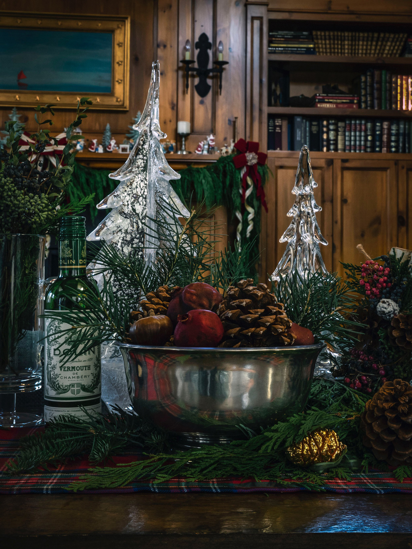 Pewter bowl filled with ornaments and pinecones