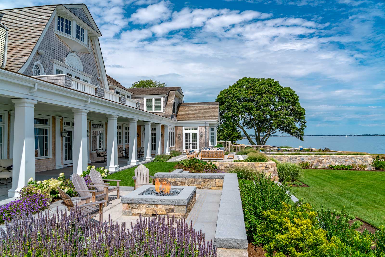 Shingle Style Ocean Home - patio with fire pit by Cumar Inc
