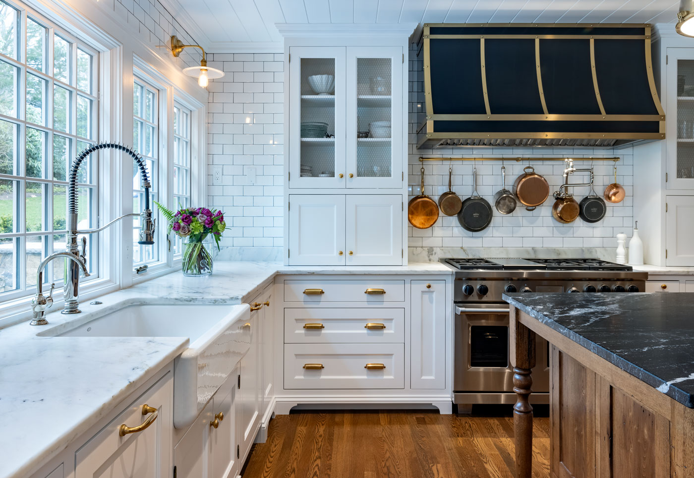 white kitchen with white tiles on the wall and countertops