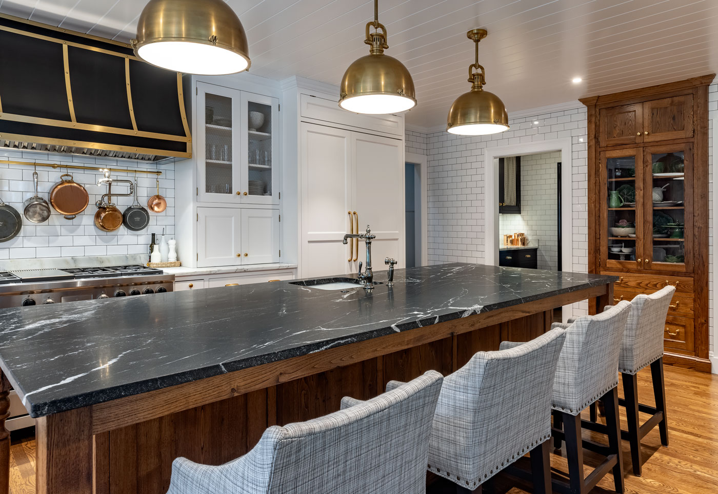 modern kitchen with big island and white tile on the walls