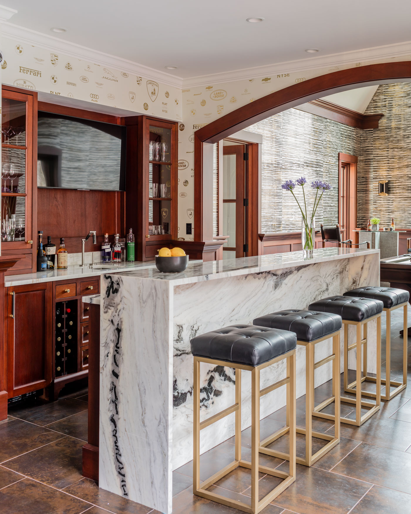 bar area with black cushioned stools