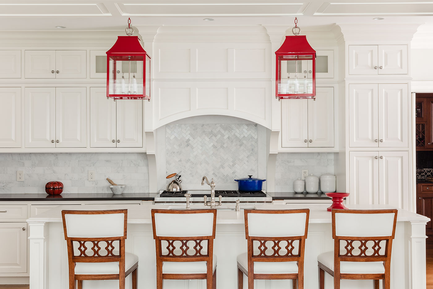 High-end red, white and blue kitchen design by Carter & Company Interior Design