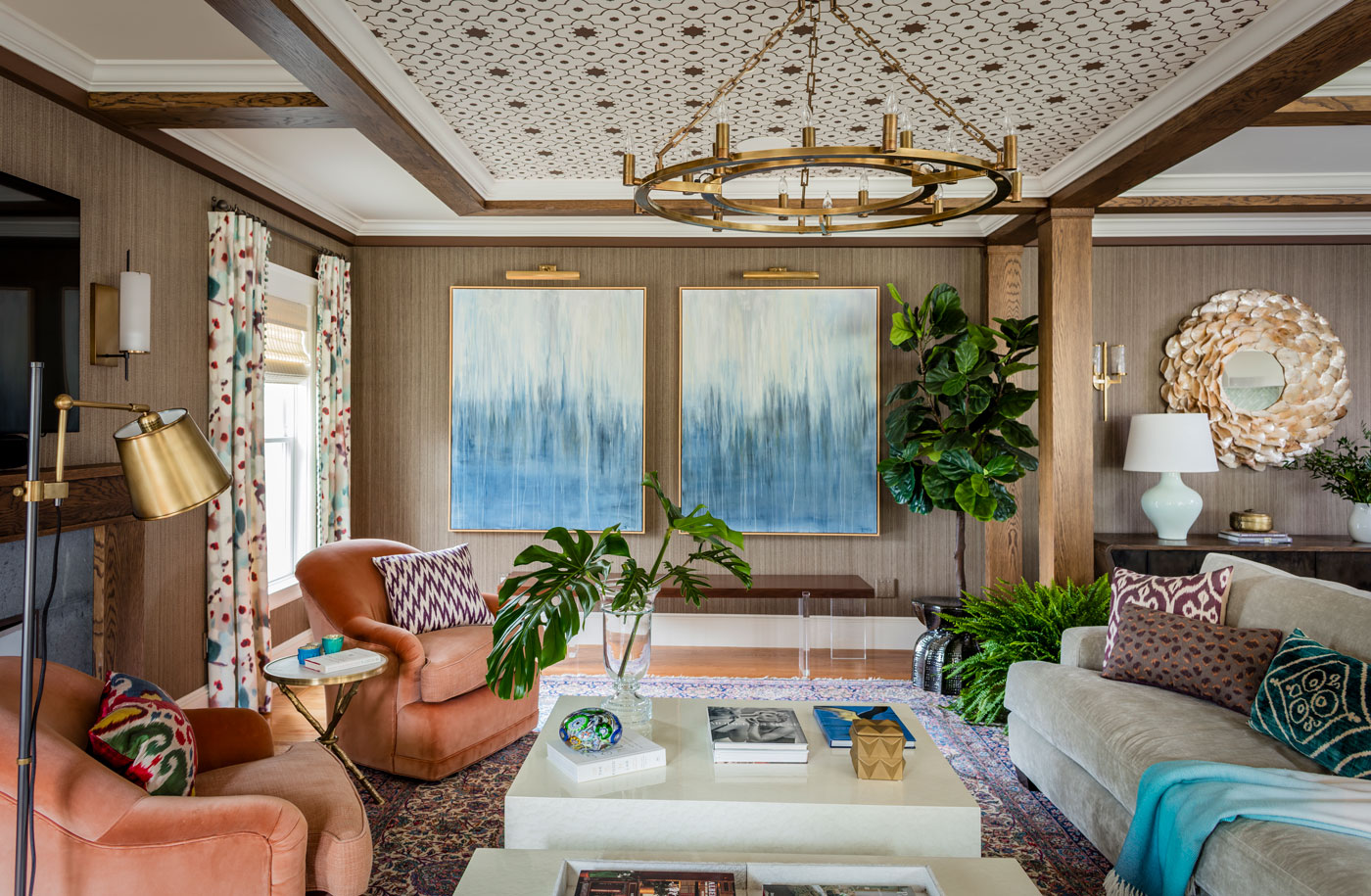 Redesigned Family room with custom ceiling blue abstract paintings on the wall and coral chairs