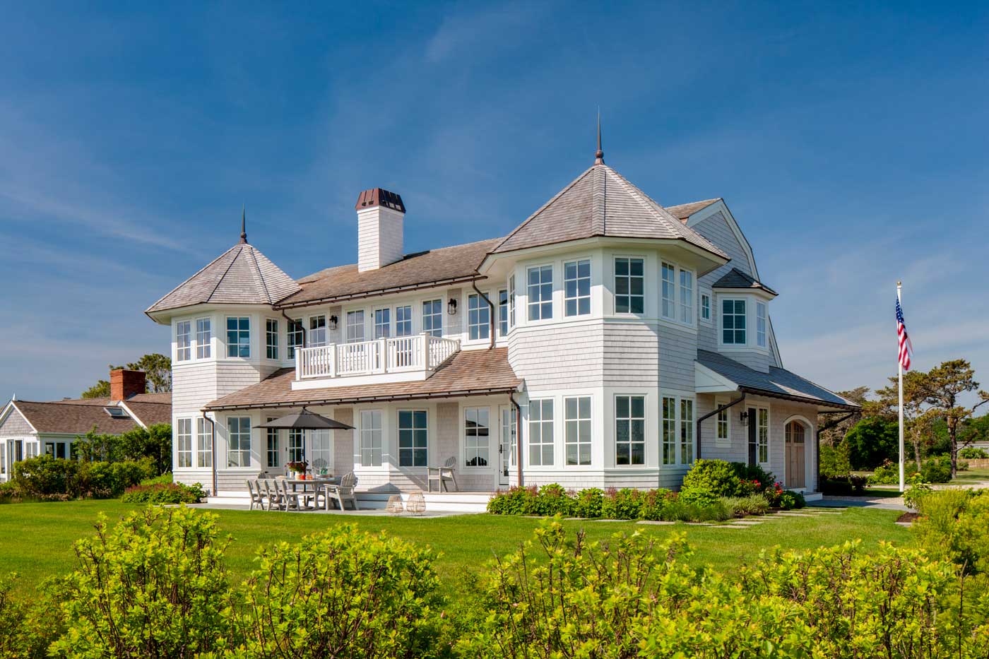 view of the back of a beautiful home along the water