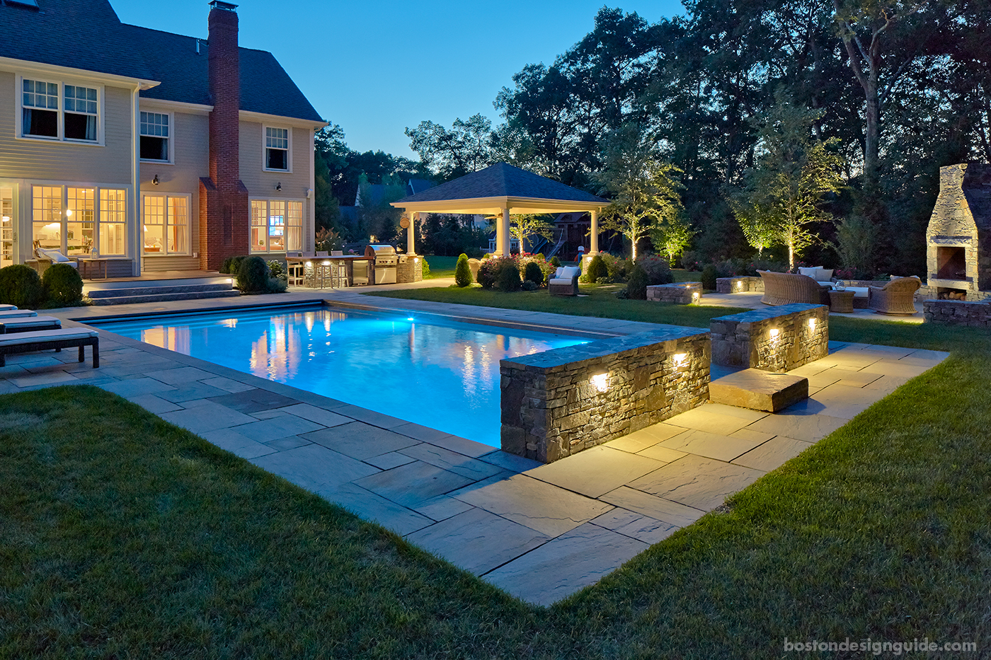 Pool terrace at night designed by a Blade of Grass