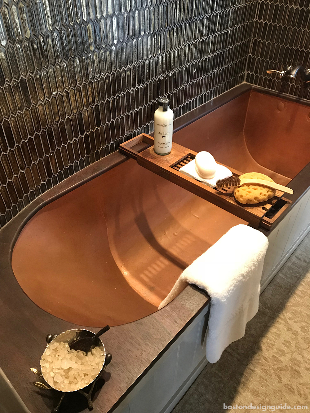 copper bathtub and tile