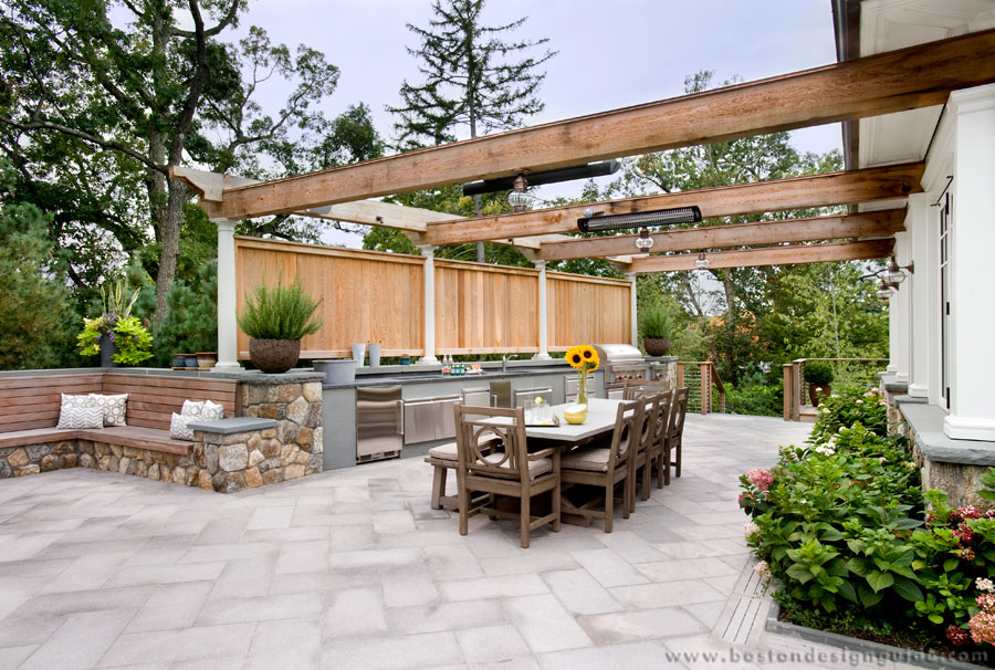 Outdoor kitchen with overhead heaters by JW Construction, Inc.