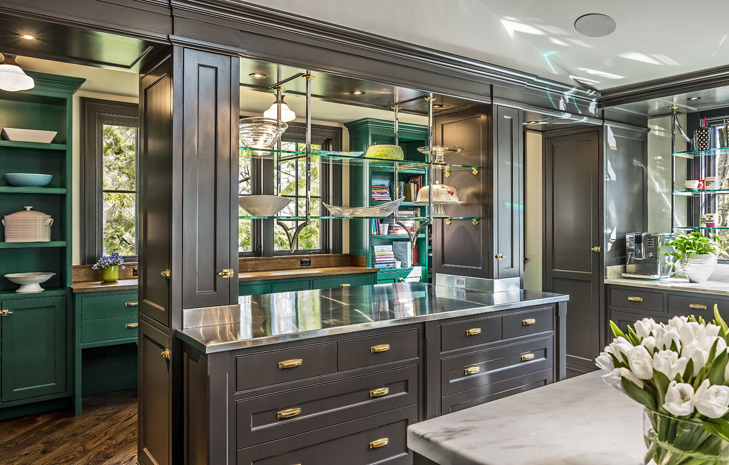 Custom cabinetry adds not only beauty and practicality; it can also create one-of-a-kind living spaces that—quite literally—are tailor made for the homeowner. For the spectacular kitchen shown here, a study in wood and glass work with an array of finishes