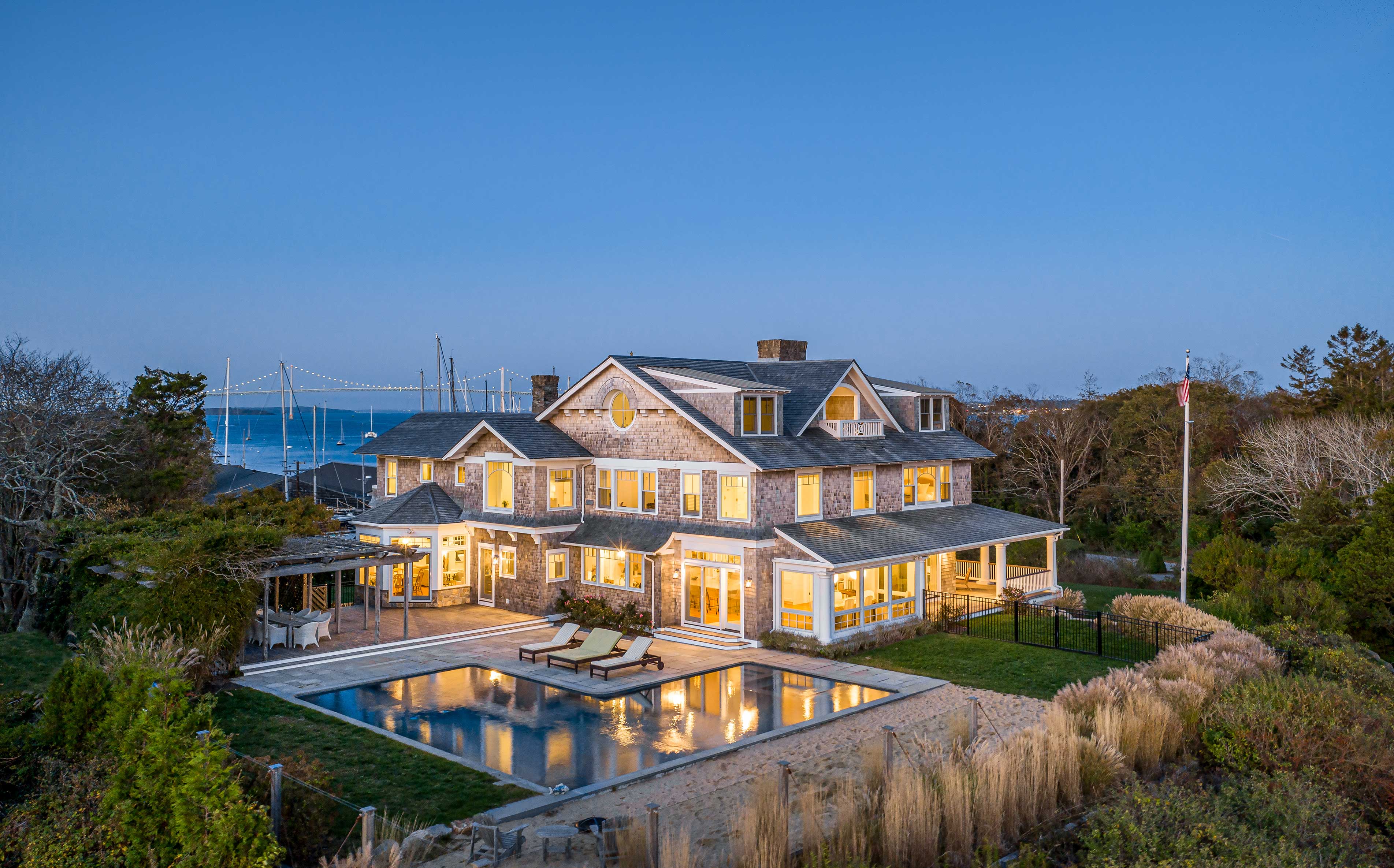 overhead view of custom home with a pool and a water view