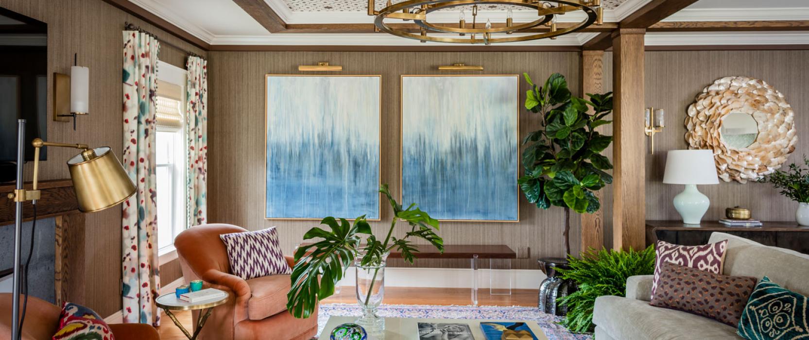 Redesigned Family room with custom ceiling blue abstract paintings on the wall and coral chairs