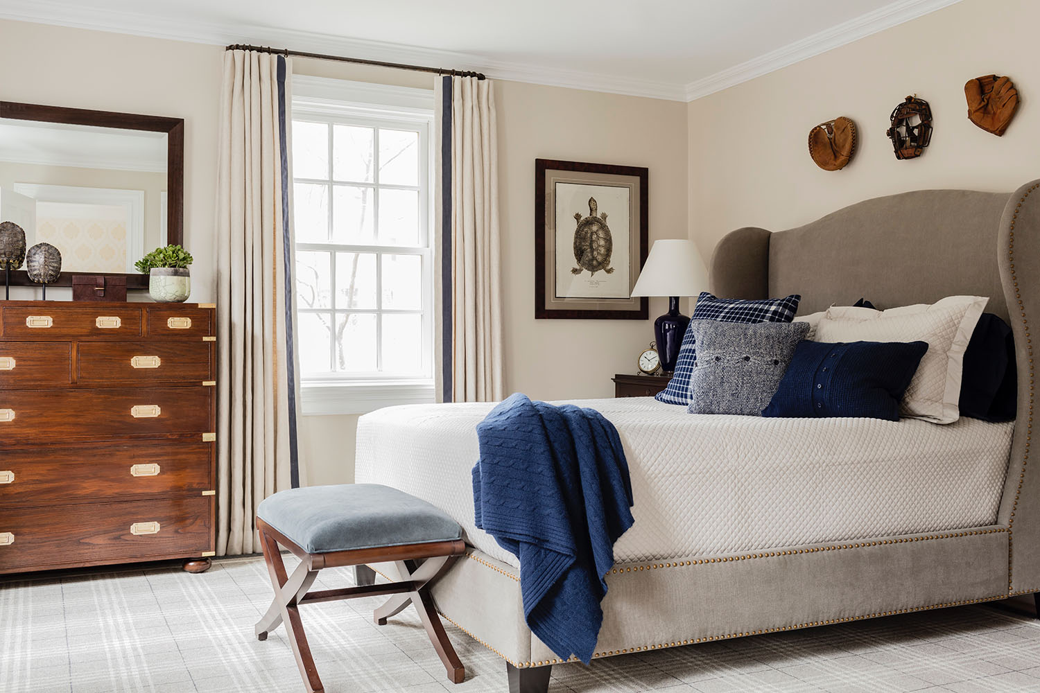 Interior Design by Theo & Isabella Design Group  For the college-aged son in the same family, those same ties to the Carolinas are expressed differently, and evoked by the turtle shells exhibited on the dresser and in the print on the wall. The shells wer
