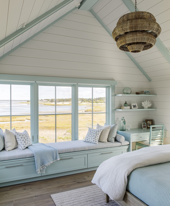 Bedroom window seat with custom cabinets below and overlooking the water