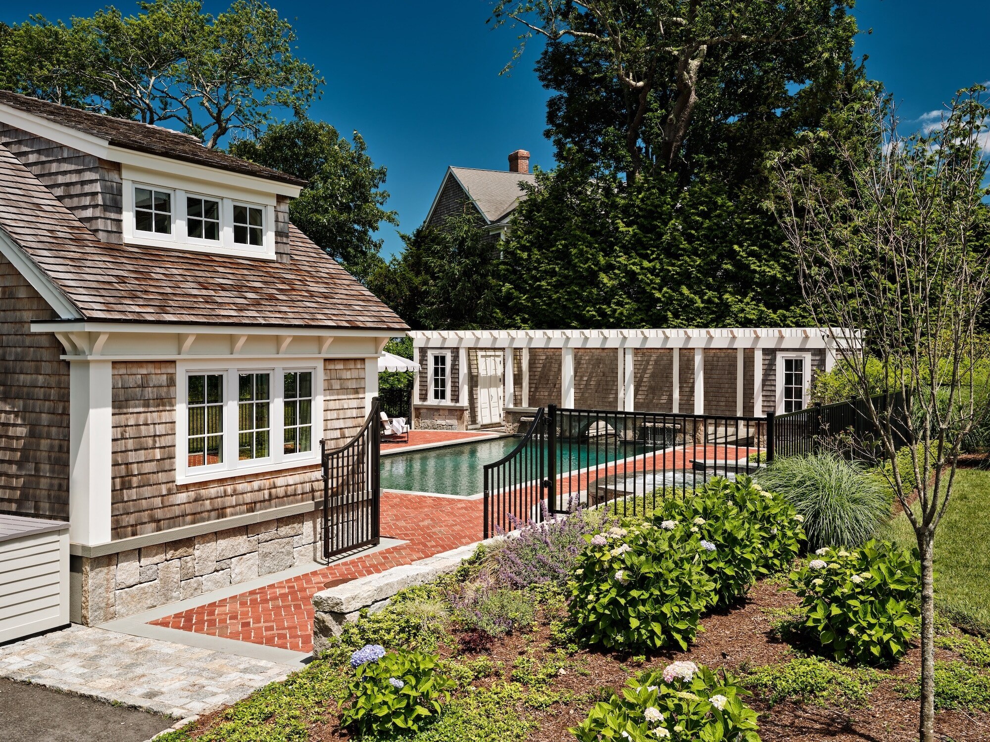 This historic home was relocated on the lot, renovated, and expanded with an addition. A few years later, a stunning pool and pool house were added, enhancing the property’s charm and functionality. Photography: Dan Cutrona